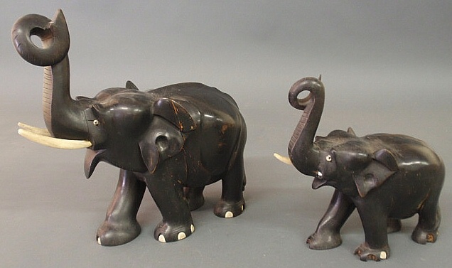 Two ebonized carved elephants with ivory