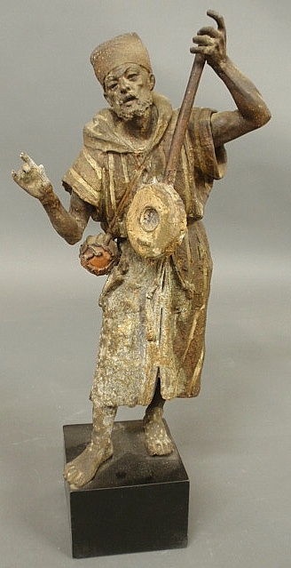 Pot metal statue of a man playing