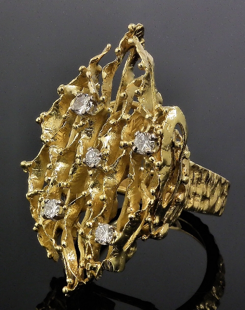 A gold coloured metal mounted diamond
