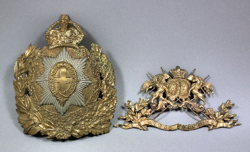 An embossed gilt brass helmet plate
