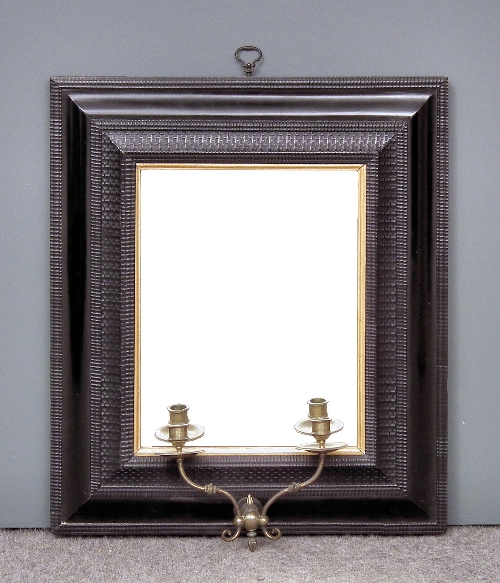 An ebonised and moulded rectangular