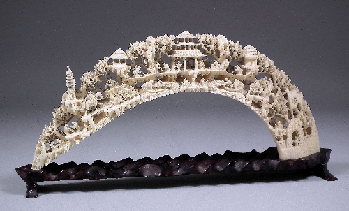 A Chinese ivory tusk carved with figures