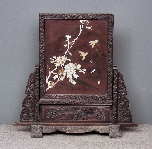 A Japanese carved and stained wood framed