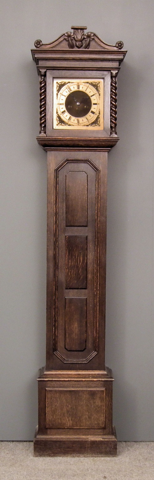 A 1920s dark oak longcase clock of Jacobean
