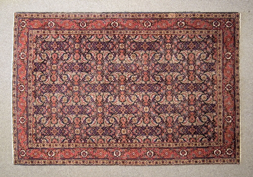 A Hamadan carpet woven in colours