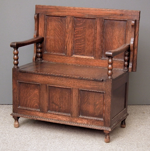 A 1920s panelled oak Monks bench