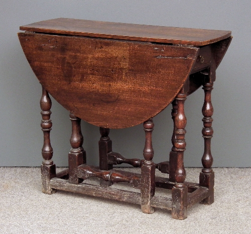 An old oak oval gateleg table of