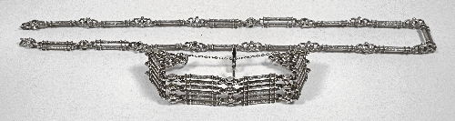 A silvery metal six bar gate link bracelet