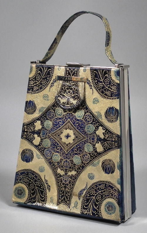 A gilt tooled blue leather handbag of