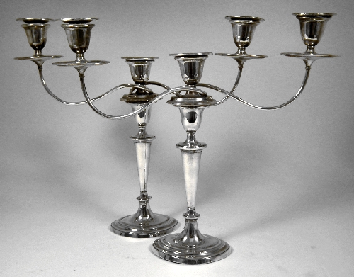 A pair of George III silver pillar candlesticks