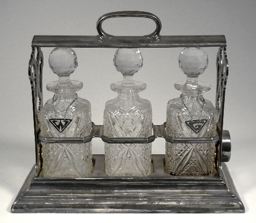 A plated framed three bottle tantalus 15ce2d