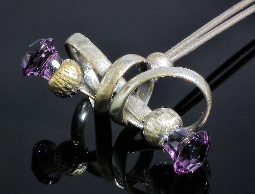 A silvery metal mounted amethyst set