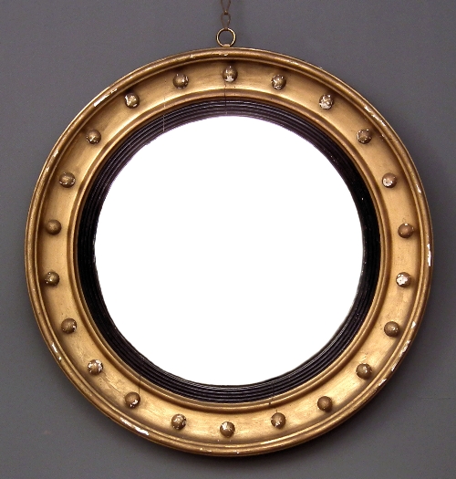 A gilt framed circular convex wall