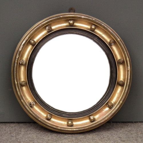 A gilt framed circular convex wall
