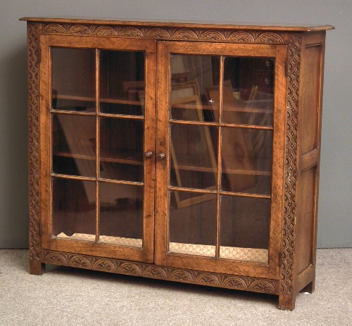 A panelled oak dwarf bookcase of