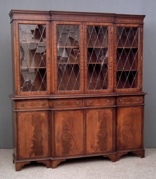 A modern mahogany break-front bookcase