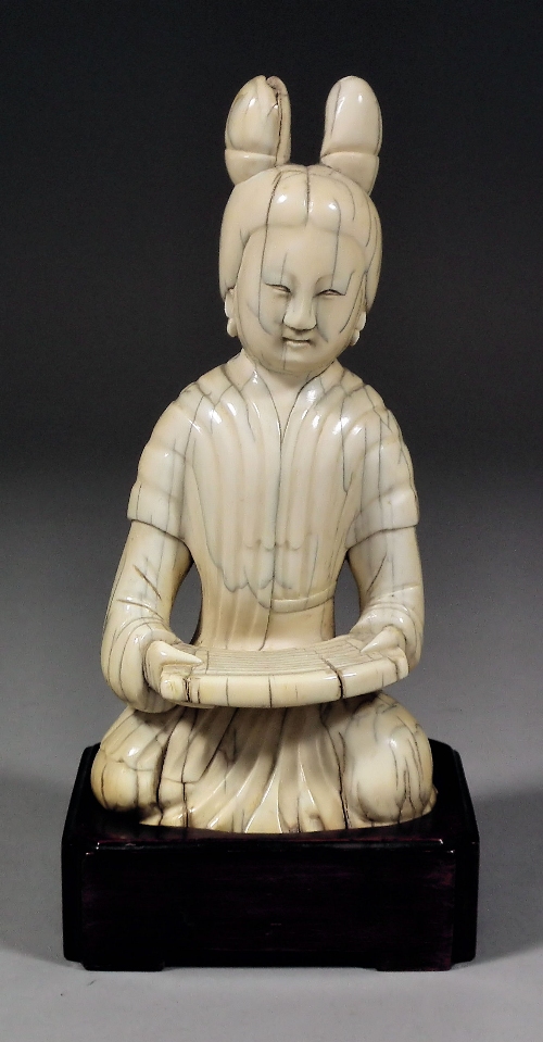 A Chinese ivory carving of a seated