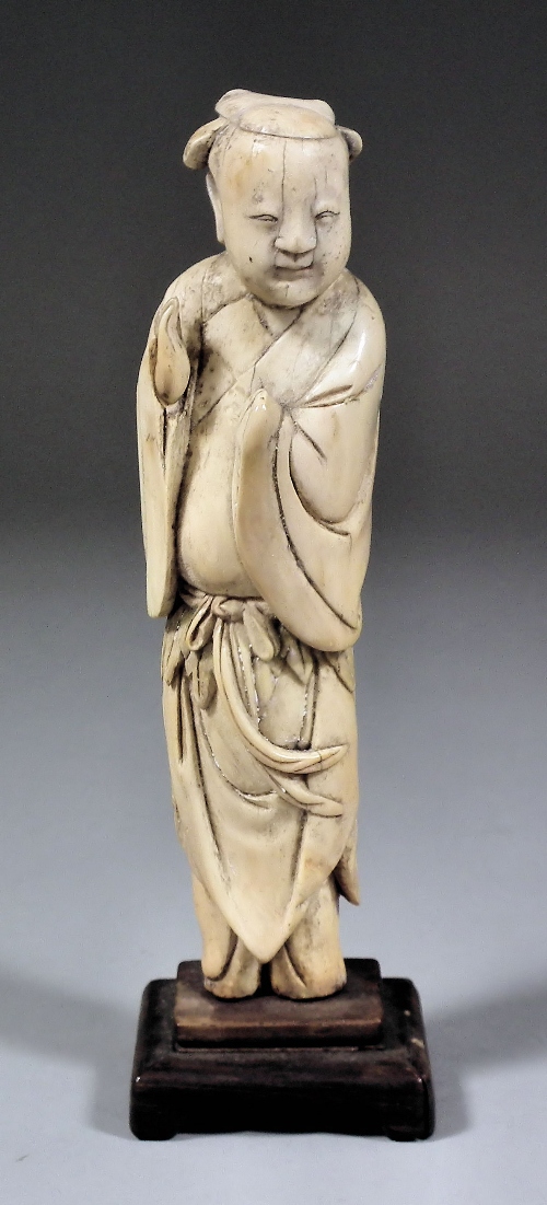 A Chinese carved ivory figure of