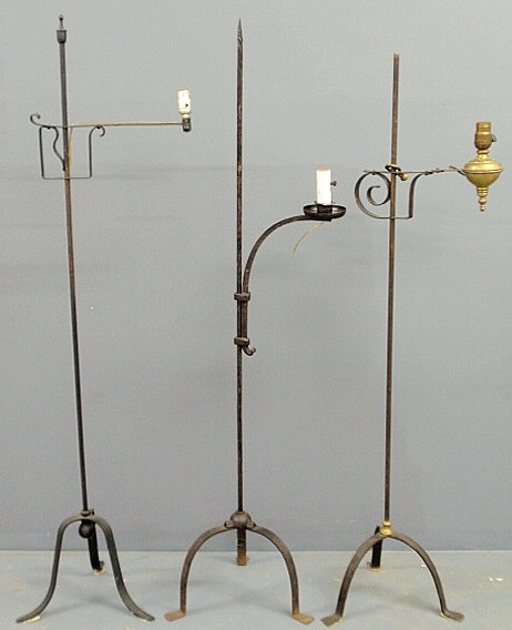 Three wrought iron standing floor lamps