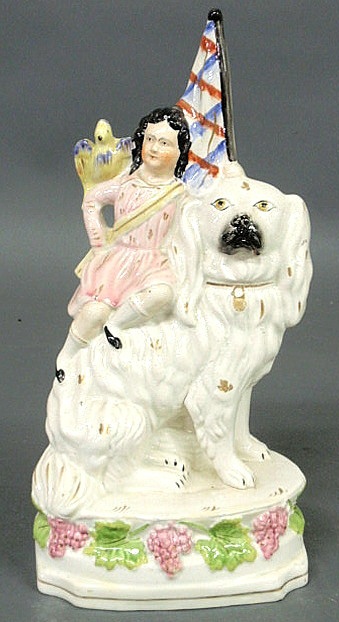 Staffordshire figure of a child riding