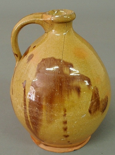Ovoid redware jug 19th c. with green/brown