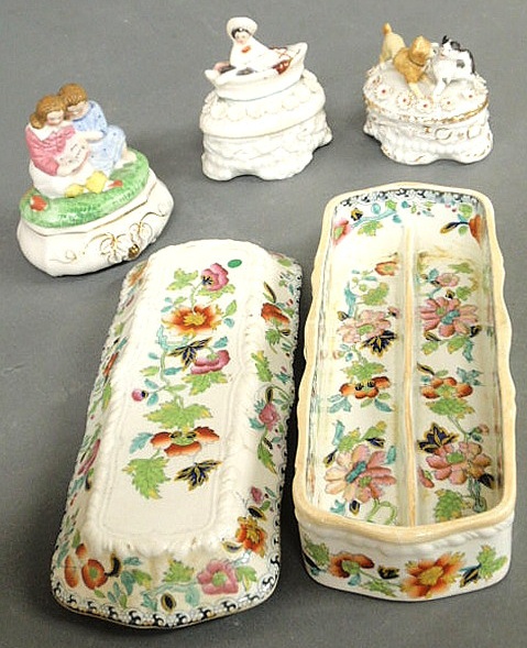 Three porcelain figural boxes and