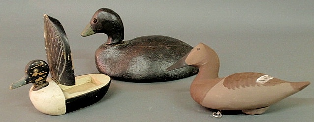 Three carved duck decoys one with a