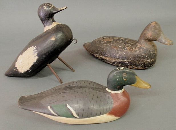Three carved duck decoys probably