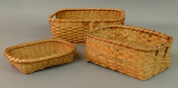 Group of three woven wood baskets