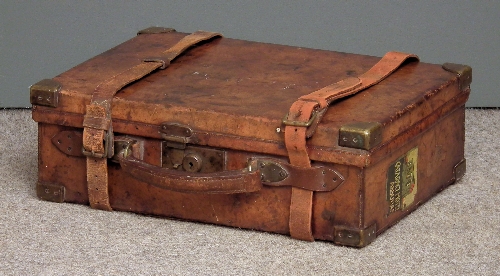 A leather and brass bound cartridge