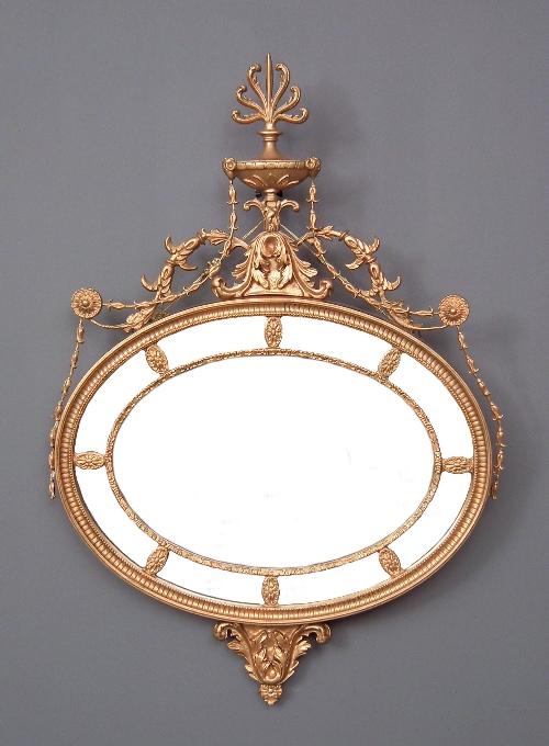 A gilt oval wall mirror of Neo-classical