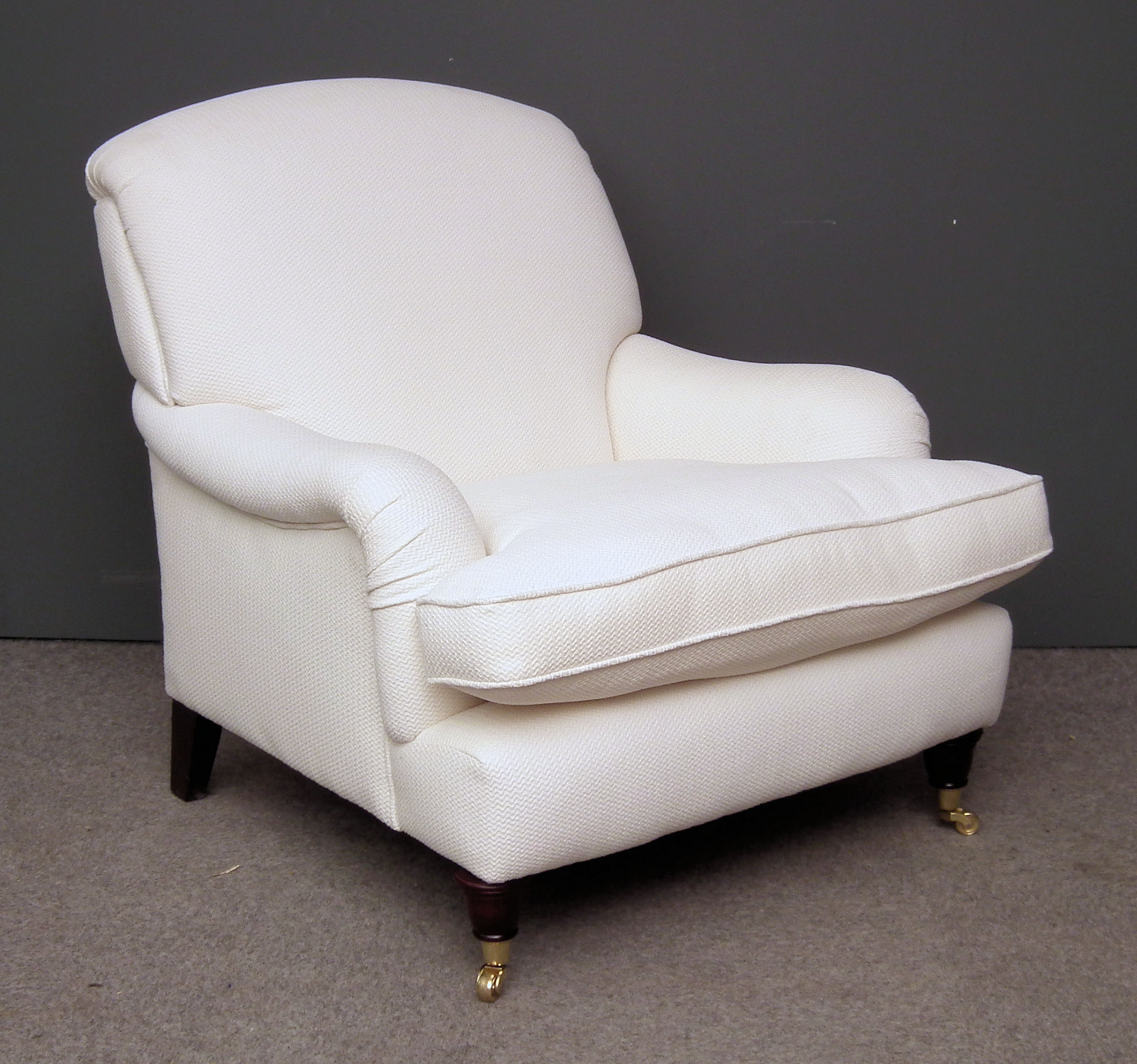 A modern easy chair upholstered in white