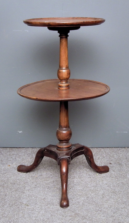 A mahogany circular two tier dumb waiter