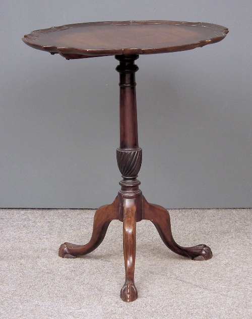 A mahogany circular tripod table