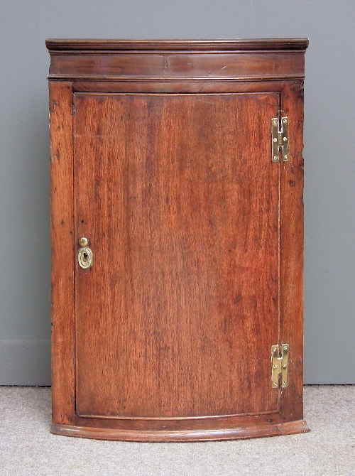 An 18th Century oak bow-front hanging