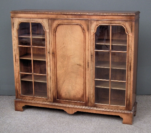 A 1930s figured walnut bookcase fitted
