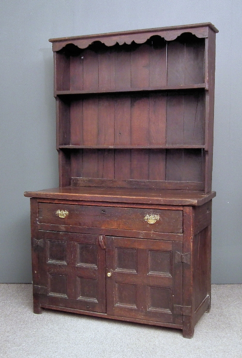 An old panelled oak dresser of