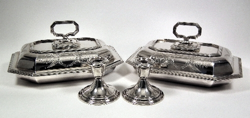 A pair of silvery metal table candlesticks