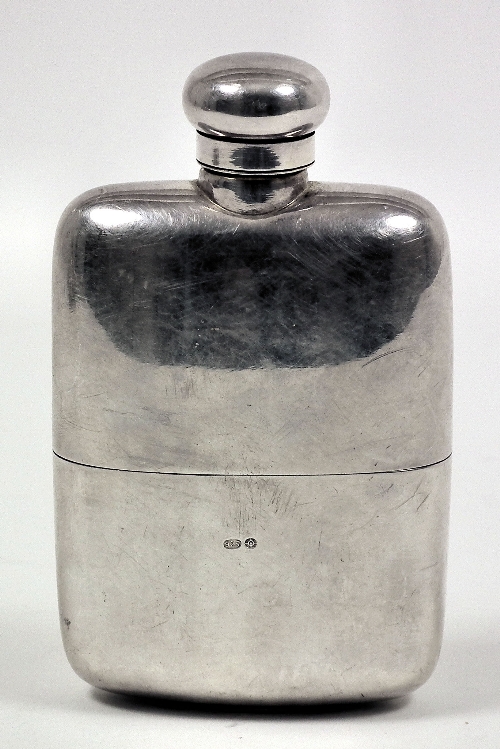 A silvery metal rectangular spirit flask