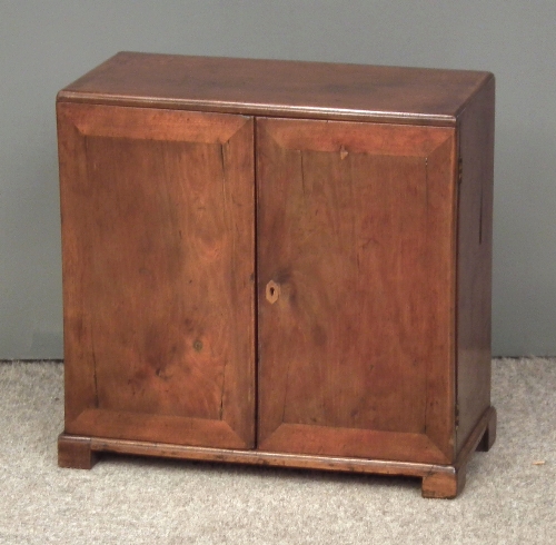 A mahogany table cabinet with fitted