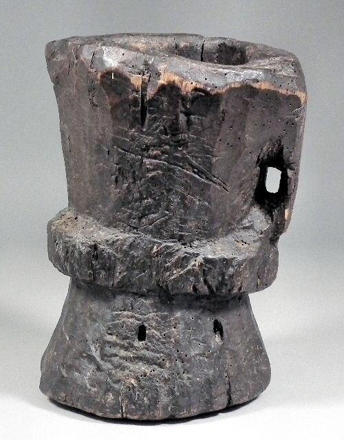 An ancient wooden mortar of waisted 15d4a6