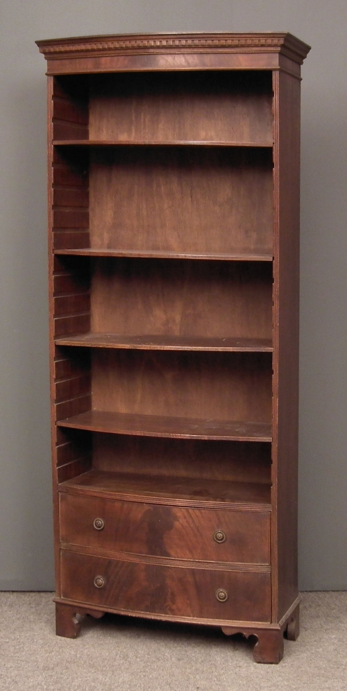 A mahogany bow and open front bookcase