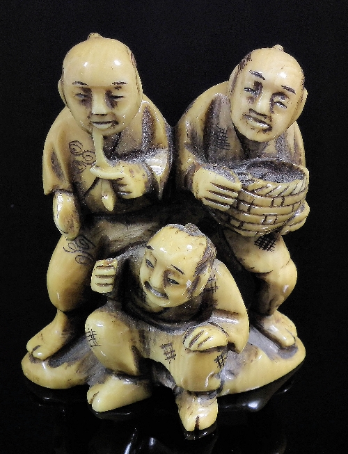 A Japanese ivory netsuke carved in the