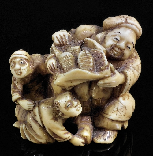 A Japanese ivory netsuke carved