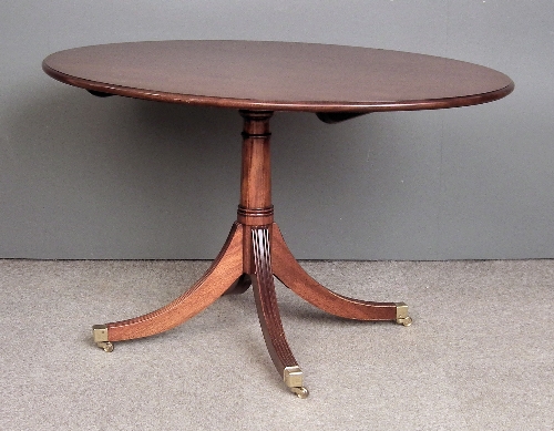 A mahogany oval breakfast table