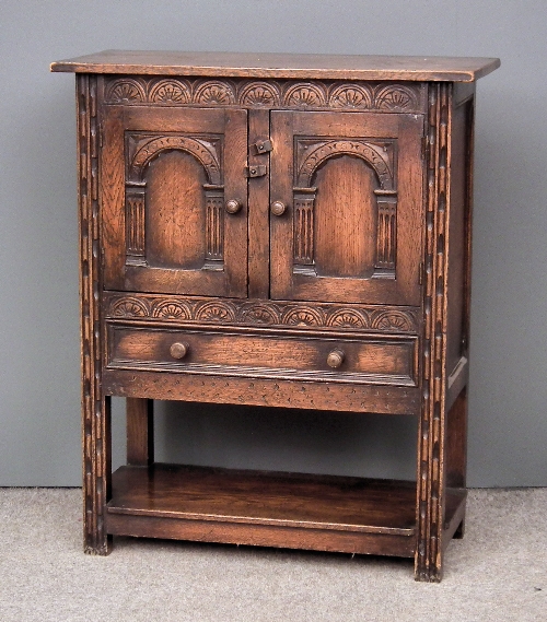 A panelled oak hall cupboard of