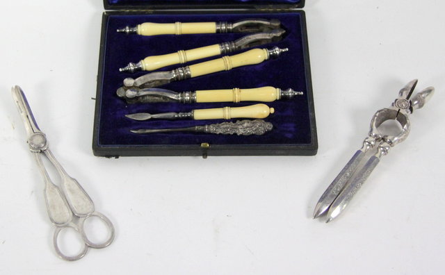 A pair of grape scissors with thread 16169d
