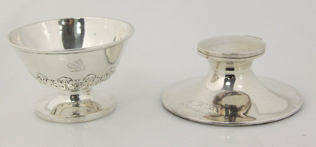 A silver capstan inkwell and a
