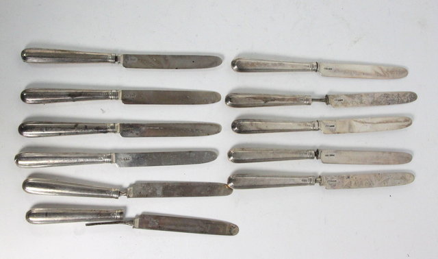 A set of eleven silver dessert knives