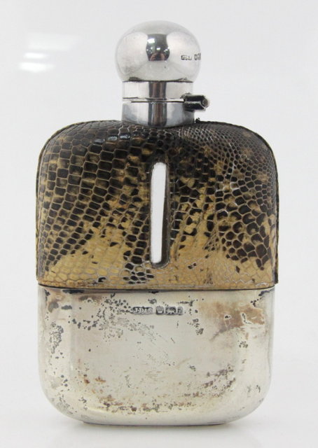 A silver and leather hip flask James